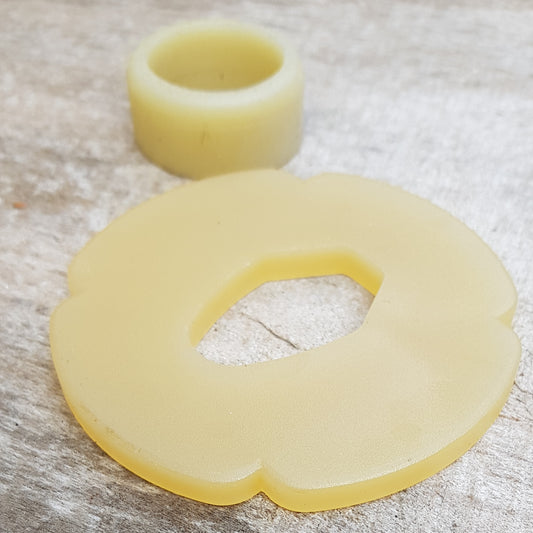 A set of plastic tsuba in black, brown, and beige colors, designed for use with wooden bokken in fencing.
