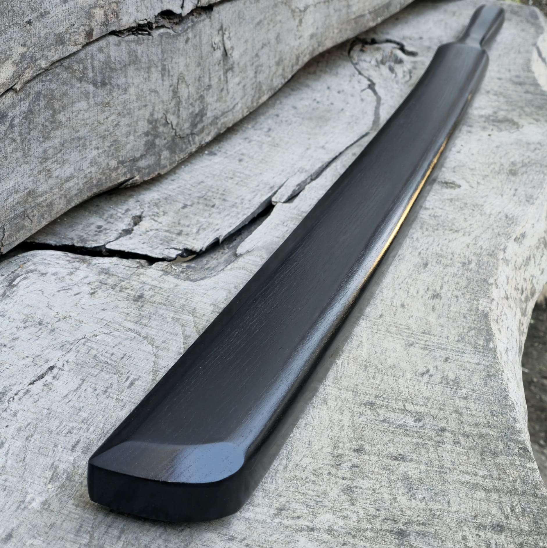 Heavy wooden suburito bokken for strength and technique training in kendo and aikido. Made from solid hardwood with a smooth, balanced design