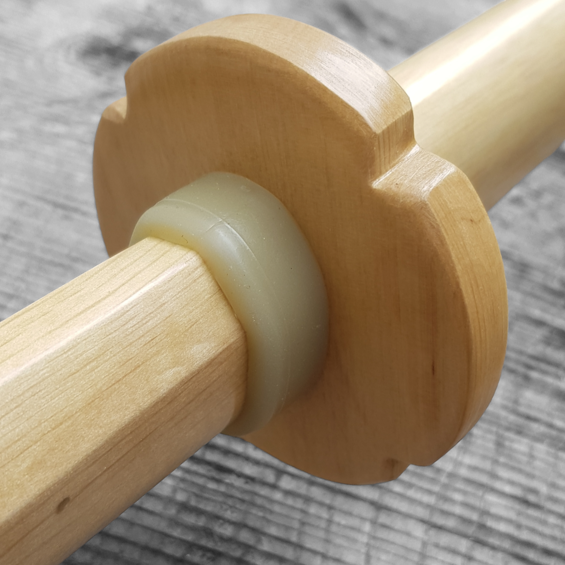 Wooden tsuba for bokken, displayed with a rubber stopper.