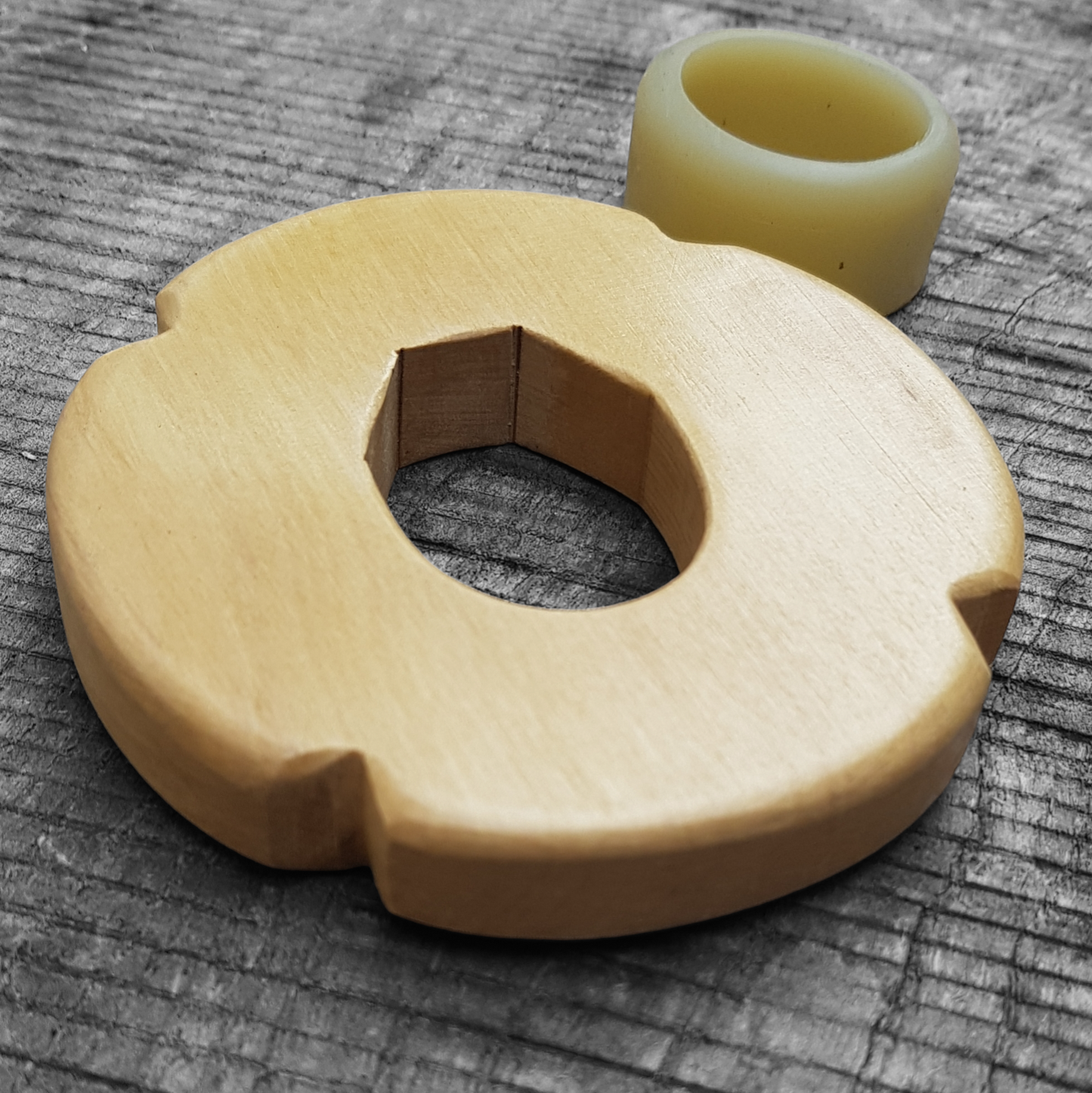 Wooden tsuba for bokken, displayed with a rubber stopper.