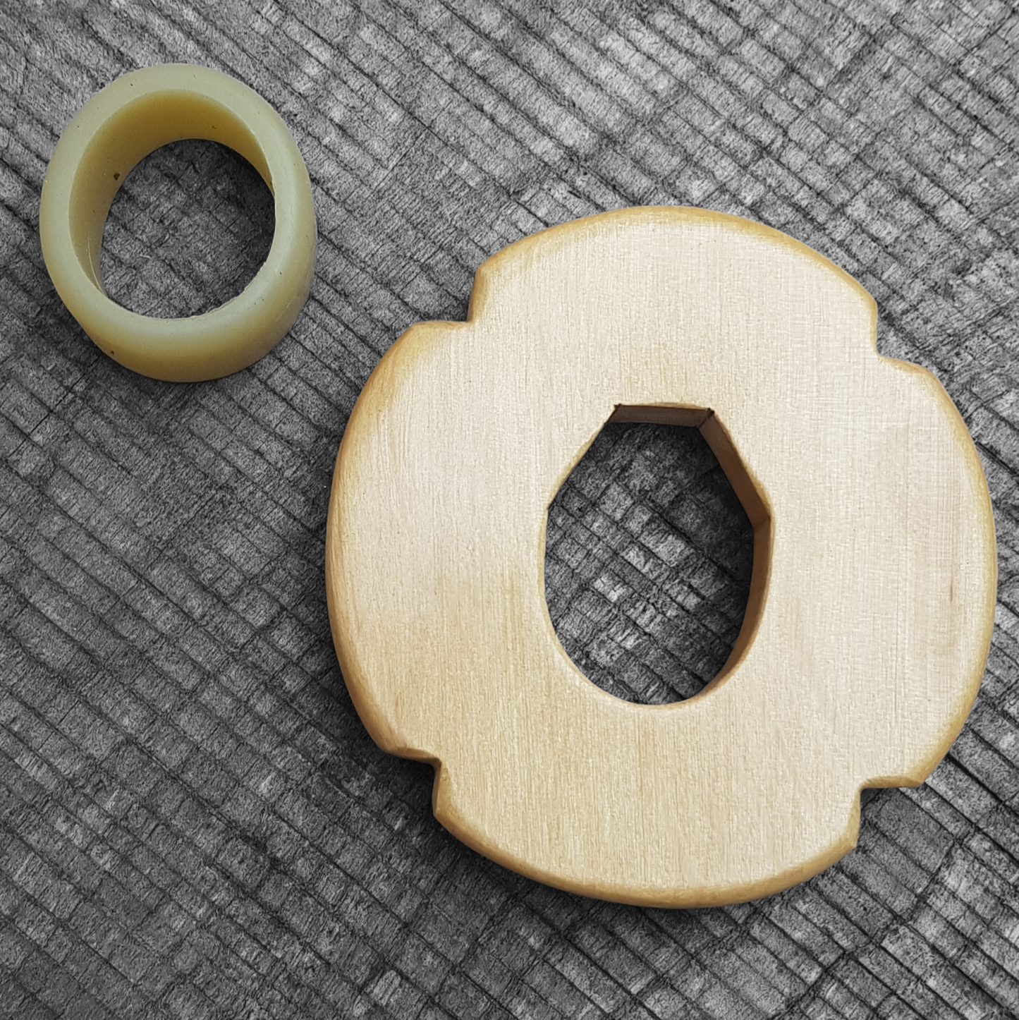 Wooden tsuba for bokken, displayed with a rubber stopper.