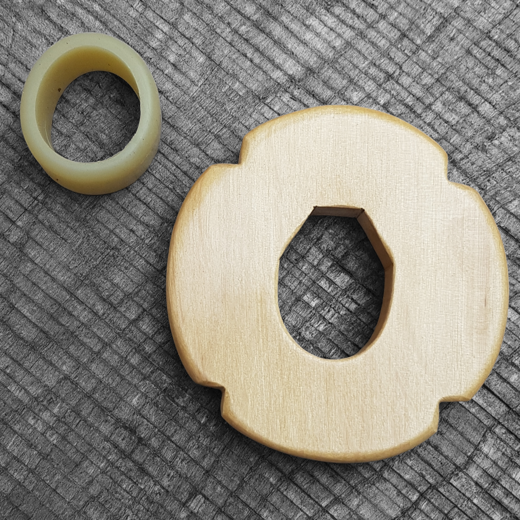 Wooden tsuba for bokken, displayed with a rubber stopper.