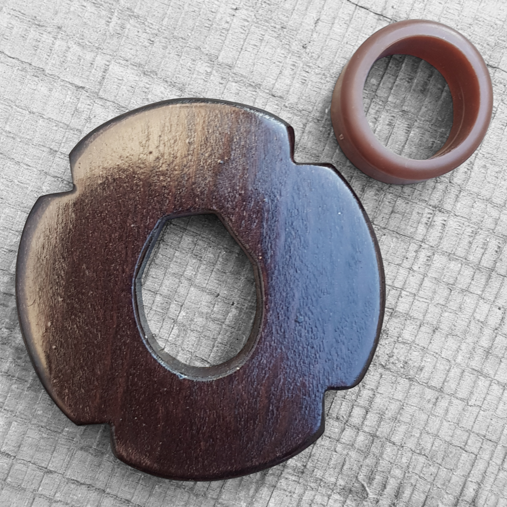Wooden tsuba for bokken, displayed with a rubber stopper.