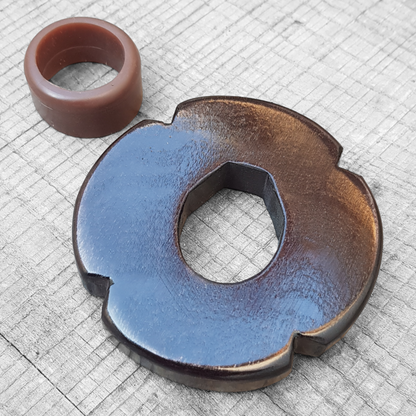 Wooden tsuba for bokken, displayed with a rubber stopper.