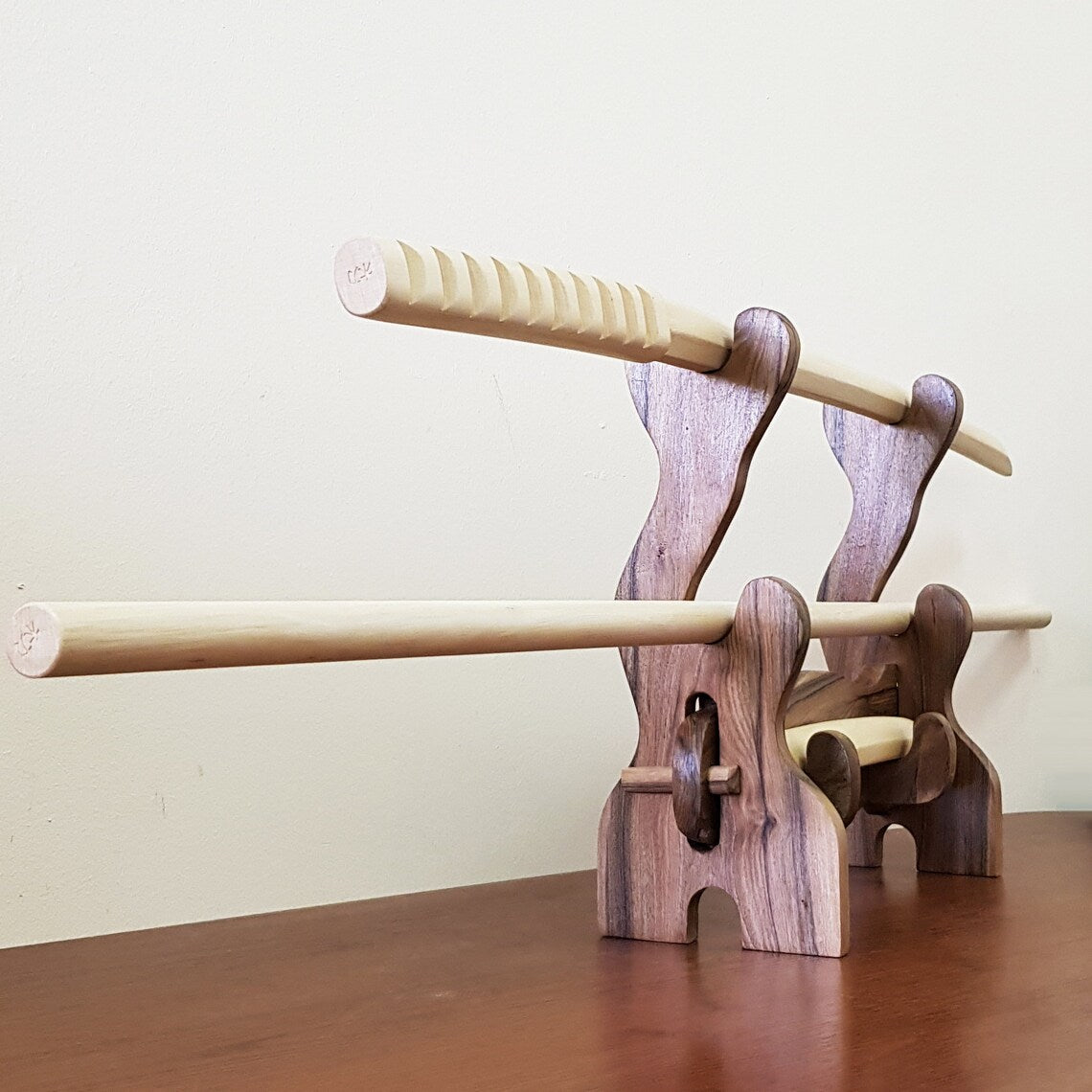 Elegant wooden stand for sword display – ideal for collectors and martial artists.